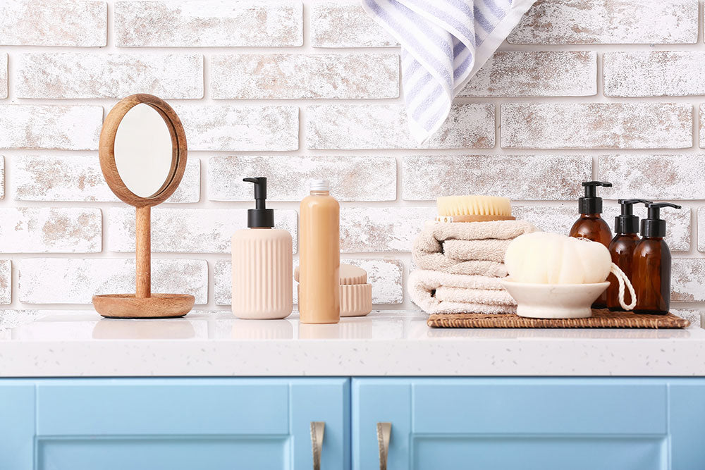 Shower gels, mirror, towels and loofah in bathroom