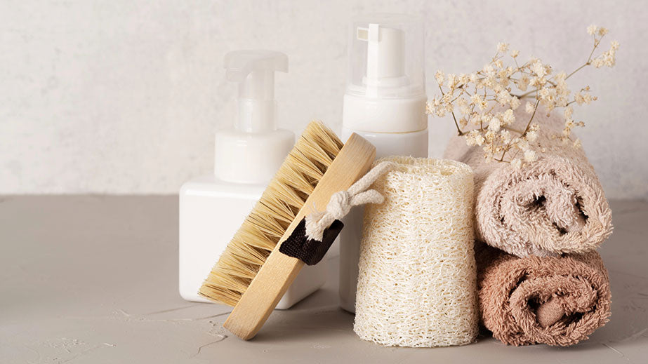 Spa cosmetic products and eco friendly bathroom accessories on gray texture background