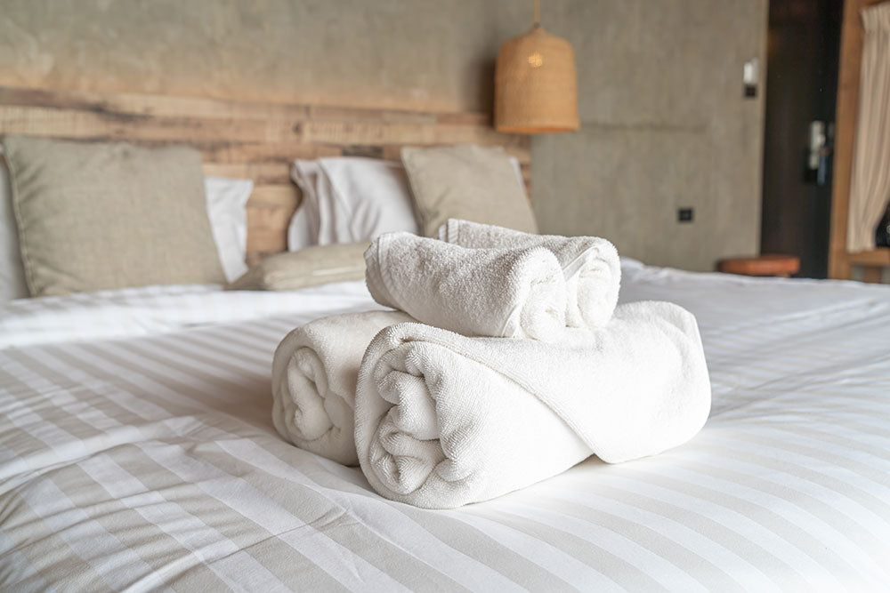 White towel on bed decoration in bedroom