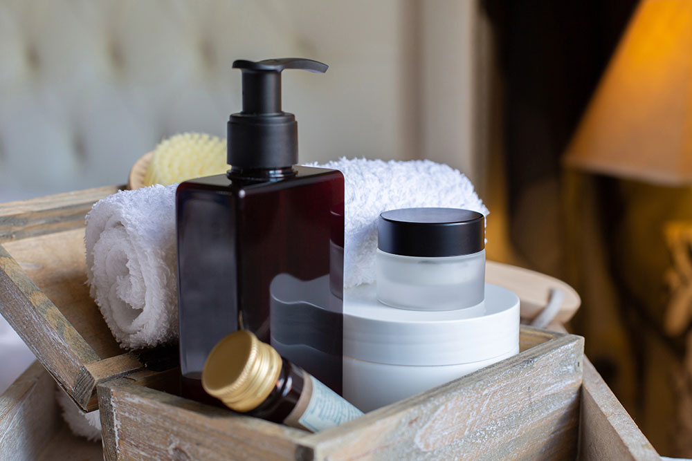 Luxury Hotel Supplies with soap dispenser, rolled towel, and spa cream jars