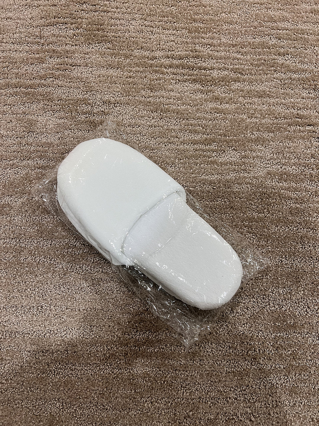 Hotel slippers white fluffy in plastic bag