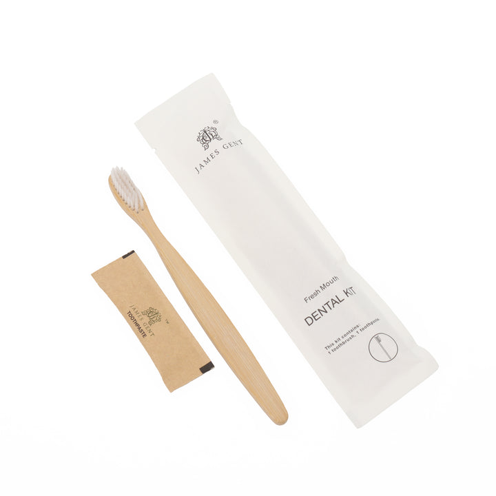 A bamboo toothbrush with white bristles, a small kraft paper sachet, and a white paper sleeve packaging, all printed with the brand name 'JAMES GENT' on a clean white background.