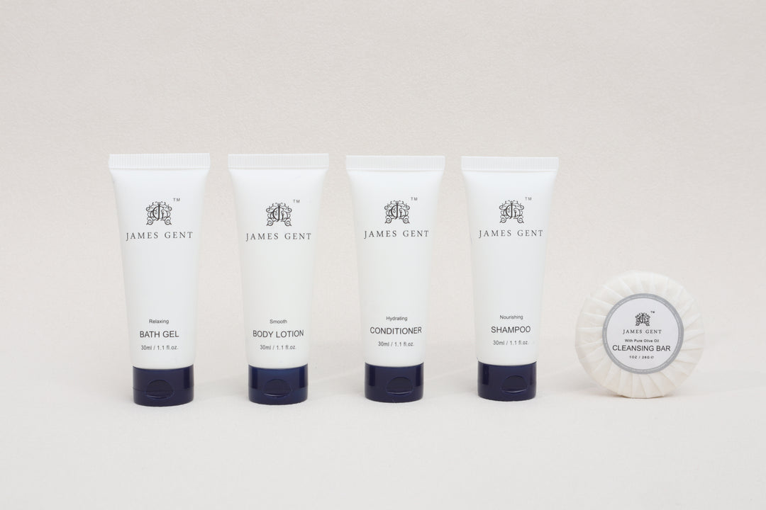 Set of James Gent skincare and hair care products including bath gel, body lotion, conditioner, shampoo, and a cleansing bar on a white background.