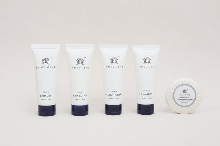 Set of James Gent skincare and hair care products including bath gel, body lotion, conditioner, shampoo, and a cleansing bar on a white background.