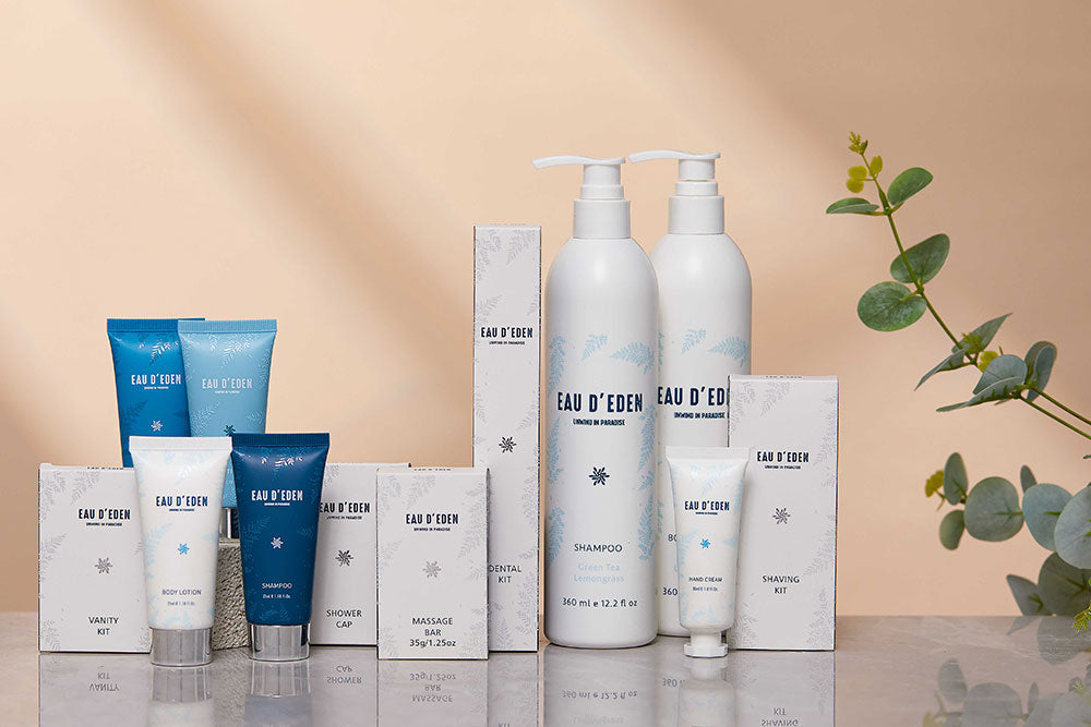 Collection of Eau d'Eden skincare and hair care products on a reflective surface with a beige background.